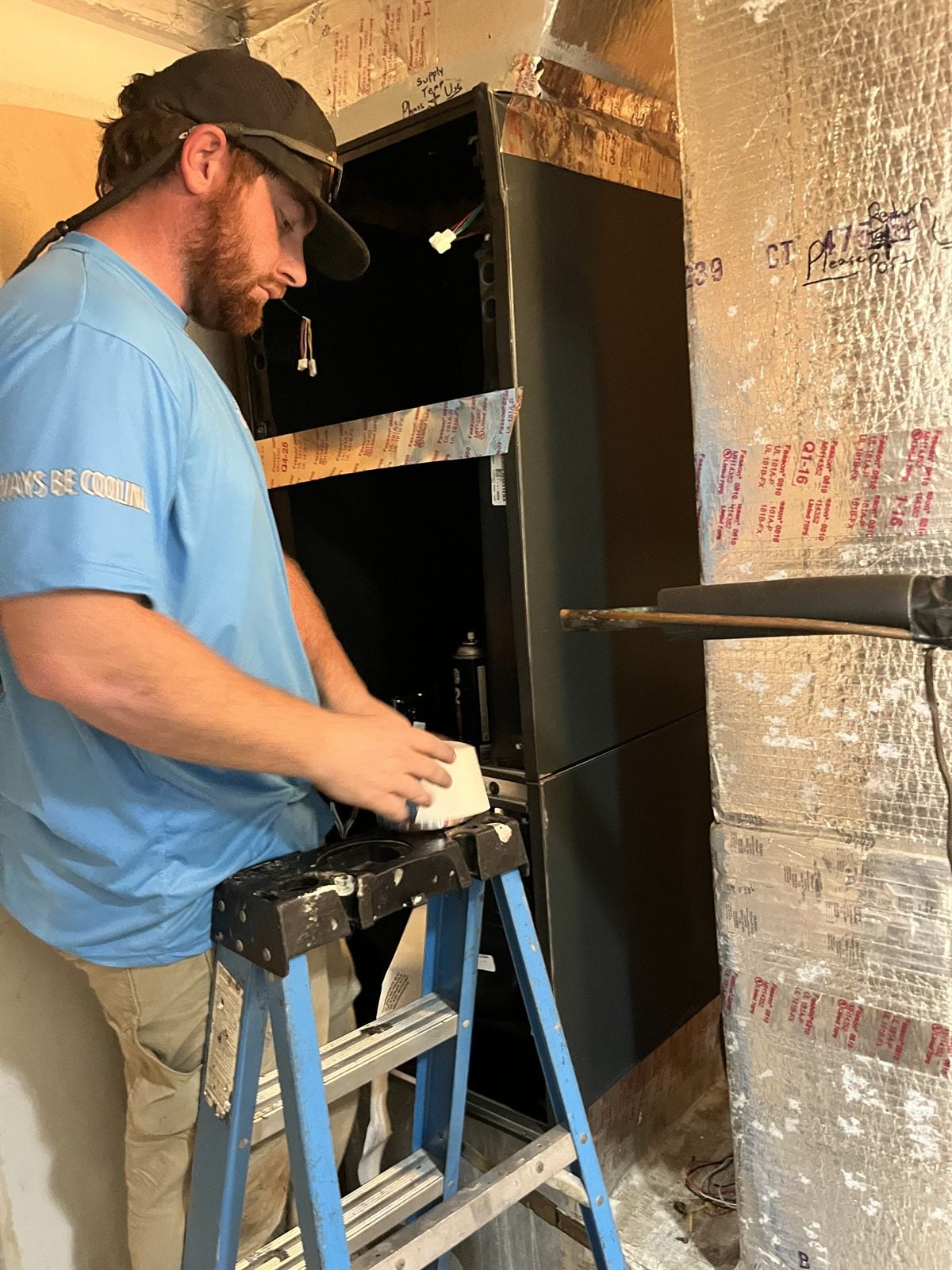Always Be Cooling technician servicing an air handler at a Naples FL home